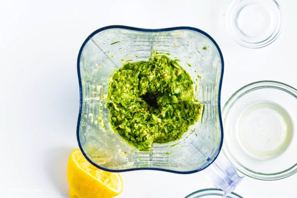 A blend of scapes, walnuts, olive oil and lemon juice in a food processor.