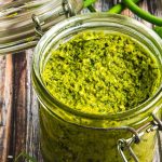 A mixture of garlic scape pesto placed in a transparent jar